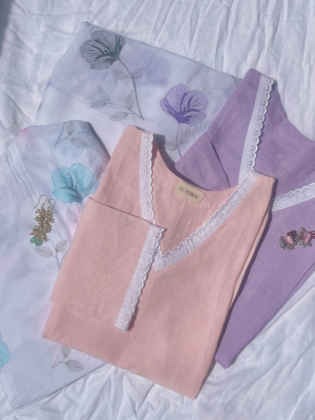 Pink and purple lace-trimmed short kurti on a floral-patterned Salwar